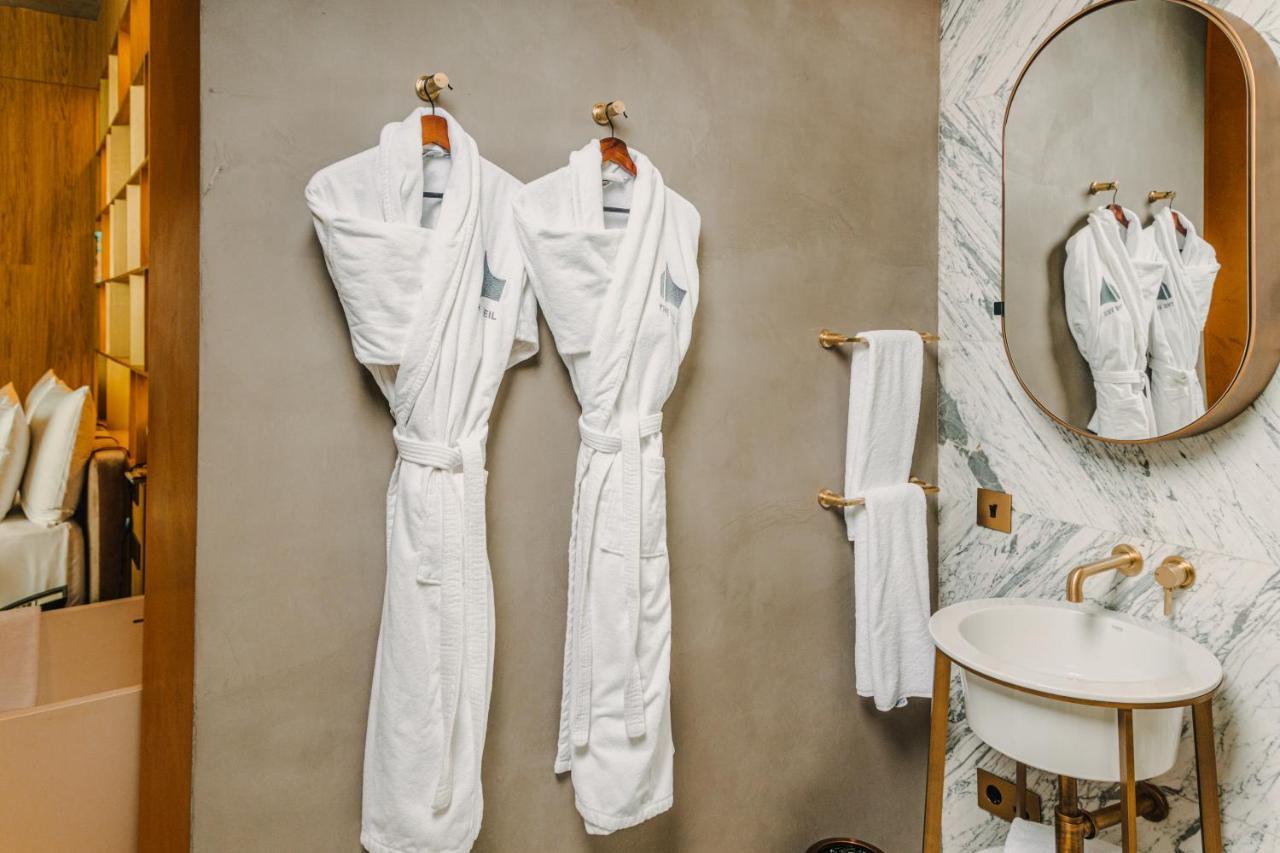 The Veil Hotel Akmola Esterno foto Bathrobes in a hotel bathroom